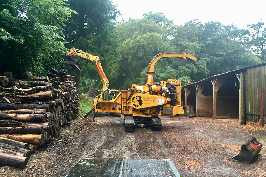 Above: Chipping into stockpile, having been unloaded from our low loader