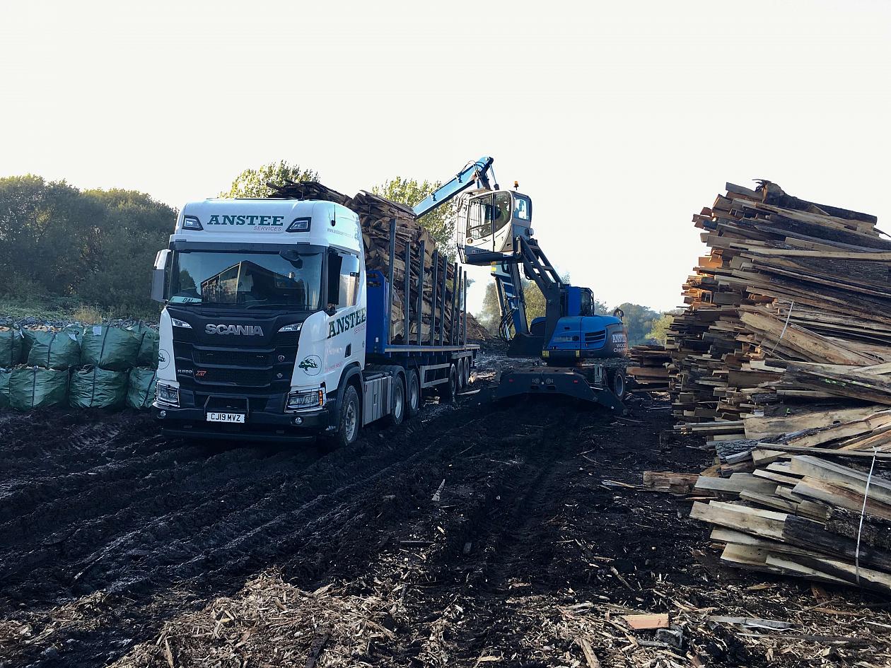 Above: Loading trailer with slab wood ready for chipping and conversion to biomass.